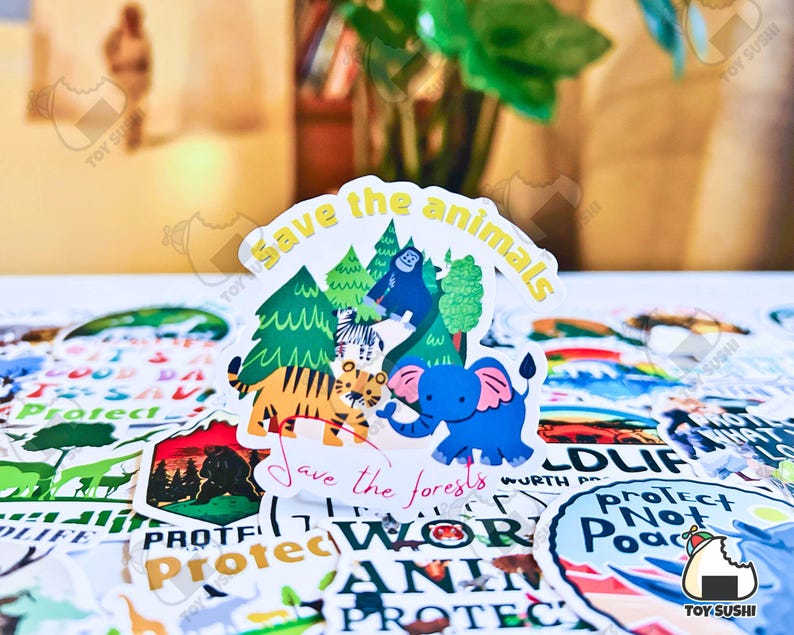 May include: A colorful sticker with a cartoon tiger, elephant, and monkey in a forest setting. The sticker says "Save the animals" and "Save the forests".