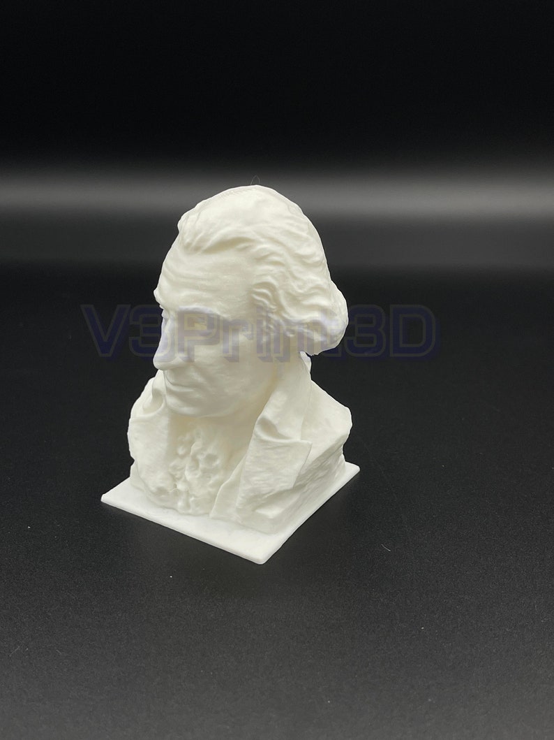 May include: A white 3D printed bust of a man with a short, curly hairstyle. The bust is on a square base.