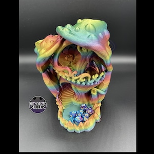 May include: A rainbow iridescent 3D printed dice tower shaped like a mushroom with a swirling design. The tower has a compartment for dice and is filled with blue and purple dice with gold numbers.