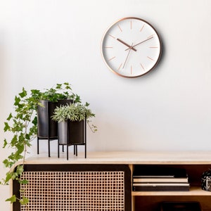 Driini Aluminum Modern Rose Gold Analog Wall Clock - Decorative Frame with White Face (12 inch) - Battery Operated, Silent, and Non-Ticking.