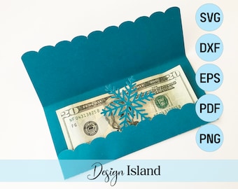 May include: A teal blue paper envelope with a scalloped edge, a snowflake cutout, and a twenty dollar bill inside. The envelope is folded in half and the bill is visible through the cutout. The text "Design Island" is printed on the bottom of the envelope.