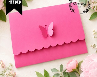 May include: A bright pink paper envelope with a scalloped flap and a central butterfly cutout. A black banner in the top left corner displays the white text NO GLUE NEEDED. A circular logo in the top right reads Dreaming SVG.