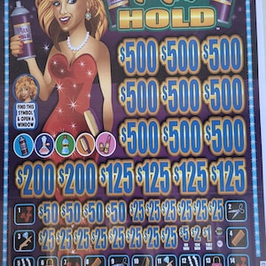May include: A Max Hold scratch-off ticket featuring a cartoon woman with blonde hair holding hairspray cans. The ticket displays prize amounts of $500, $200, $125, $50, $25, $5, $2, and $1. The ticket also has symbols like a comb, lipstick, and purse.
