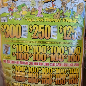 May include: A lottery ticket packet with the text "Family Tradition" in a yellow and orange font. The packet features cartoon illustrations of people and the phrase "All My Rowdy Friends." The ticket values are displayed in large dollar amounts.