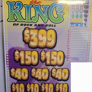 May include: A colorful lottery ticket with the text "ELVIS the KING OF ROCK AND ROLL". The ticket features various prize amounts, including $399, $150, $40, and $10. The ticket also has a section with numbers.