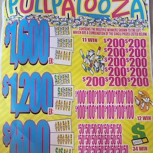 May include: A yellow Pullpalooza lottery ticket with large blue numbers indicating potential winnings of $1,600, $1,200, and $800. The ticket displays various prize amounts, including $200, $100, and $50, with the text "WINNER" visible.