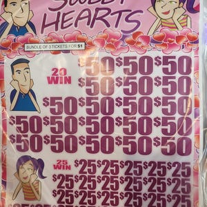 May include: A pink and white Sweet Hearts scratch card with the text "SWEET HEARTS" at the top. The card features illustrations of a man and woman, along with rows of £50 and £25 prize amounts. The text "BUNDLE OF 3 TICKETS FOR £1" is also visible.