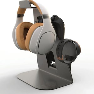 May include: A black metal stand with a white and brown headset and a black watch strap resting on it.
