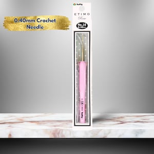 May include: A pink crochet hook with a gold tip, packaged in a clear plastic sleeve. The packaging has the text "ETIMO Rose No. 16 0.40mm Tulip" printed on it. The hook is 0.40mm in size.