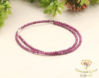 May include: A double-strand bracelet made of pink gemstone beads. The bracelet is made of small, round beads that are strung together on a silver chain.