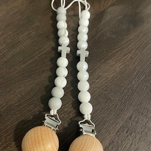 Cross paci clip
