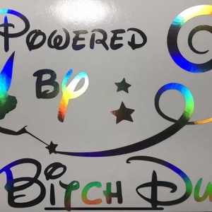 May include: A rainbow iridescent vinyl sticker with a silhouette of Tinkerbell, a swirl design, and the text "Powered By Bitch Dust".