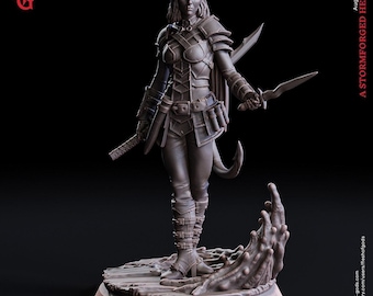 May include: A gray resin miniature figure of a horned warrior named Oriana Von Hardenburg, standing on a 25 mm base. The figure wears detailed armor, holds a dagger in one hand and a sword in the other, and features a tail and textured base.