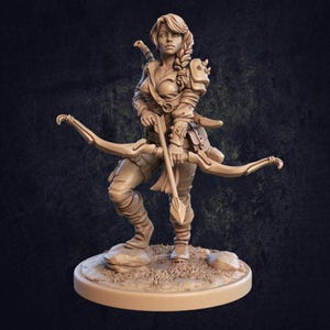 May include: A tan-coloured miniature figurine of an archer standing on a rocky base. The figure has a braided hairstyle, wears textured armour, and holds a bow in one hand and an arrow in the other. A sword hilt is visible behind the shoulder.