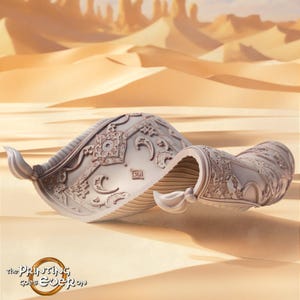 May include: A light-colored, sculpted miniature of a flying carpet featuring intricate embossed patterns of crescent moons, stars, and geometric shapes. The object has curled corners and a textured surface, with the text "the Printing goes Ever on" visible in the bottom left corner.
