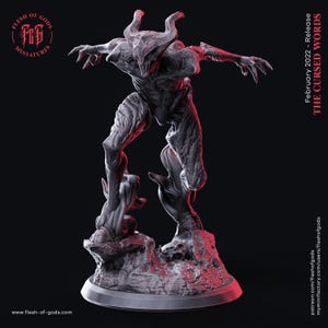 May include: A dark grey, horned creature miniature standing on a rocky base with a smaller figure beneath its foot. The figure features sharp claws, a textured muscular body, and an open mouth. Text on the image reads Flesh of Gods Miniatures, February 2022 - Release THE CURSED WORDS, and www.flesh-of-gods.com.