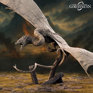 May include: A grey dragon figurine with large, outstretched wings, a long tail, and a textured, scaled body. The dragon is posed in a dynamic, mid-flight position with its mouth open, perched atop two dark, weathered wooden logs. Text reads: THE PRINTING GOES EVER ON.