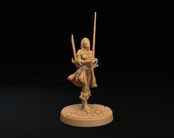 May include: A light tan unpainted miniature figurine of a hooded warrior standing on a circular cobblestone base. The figure wears armour, a flowing cloak, and holds a long sword in one hand while a second sword is positioned behind the back.