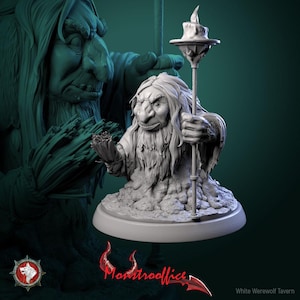 May include: A white, detailed sculpture of a troll-like creature holding a candle-topped staff and a bundle of twigs. The sculpture is on a round base, with a larger, shadowy figure in the background. The text "Montrooffice" is visible.