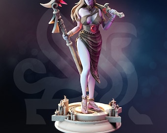 May include: A pale-skinned female elf figurine named Kadna Moonborn, wearing a dark brown draped garment with a red crescent moon emblem. She holds a tall staff with pink crystals and a sword, standing on a circular base with sculpted candles.