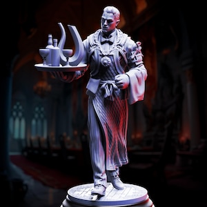 May include: A grey-toned miniature figurine of a butler wearing a formal vest, bowtie, and apron, holding a circular tray with two bottles, two goblets, and a curved decanter. The figure stands on a circular base with a textured floor pattern.
