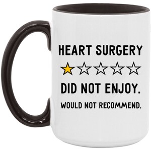 Pu&ograve; includere: Una tazza da caff&egrave; bianca con manico e bordo neri. La tazza ha un divertente detto che recita "Chirurgia cardiaca  ★★★★★ Non mi &egrave; piaciuta. Non la consiglio."