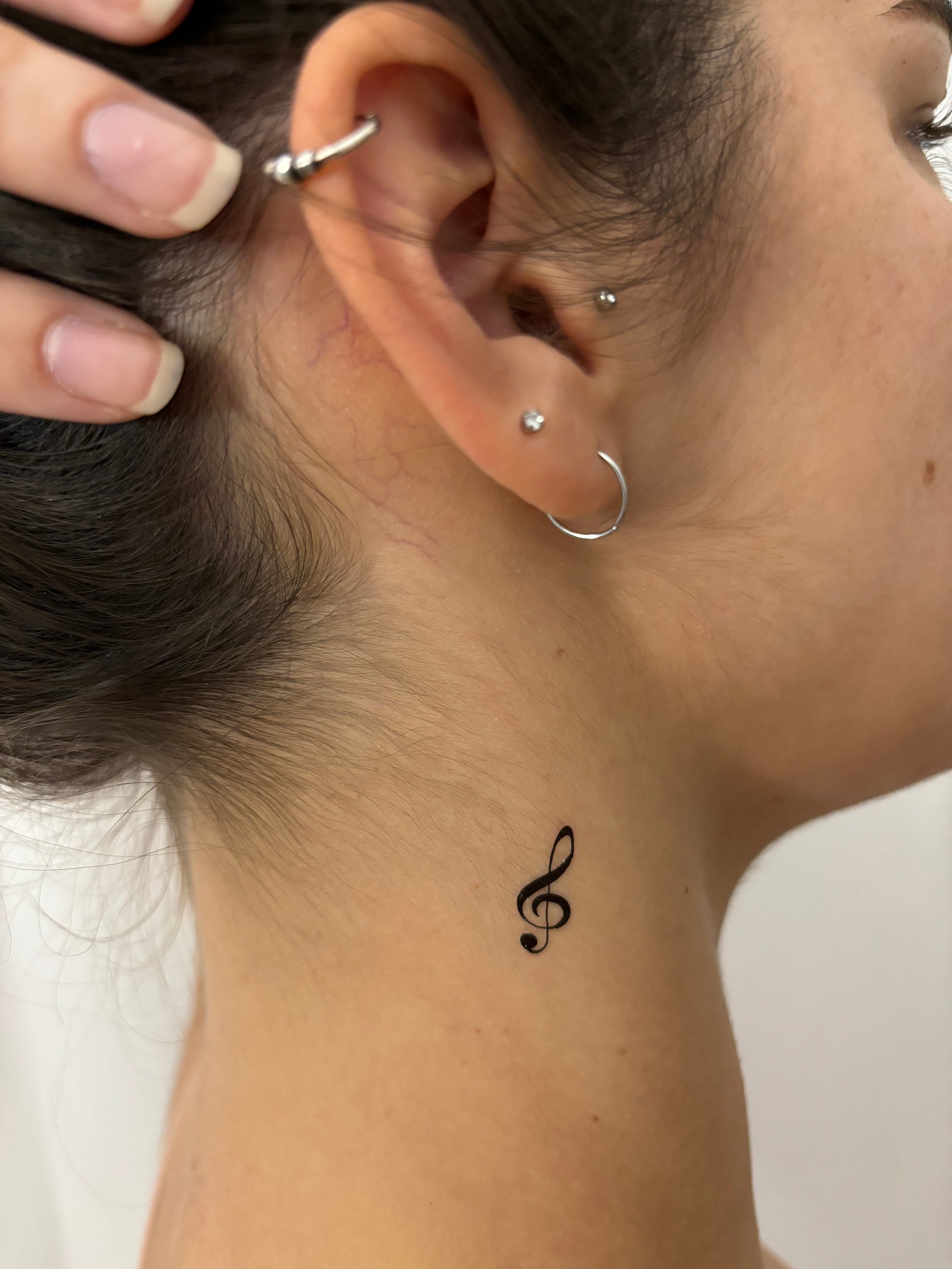 Ear-Tickling Music Note Tattoos