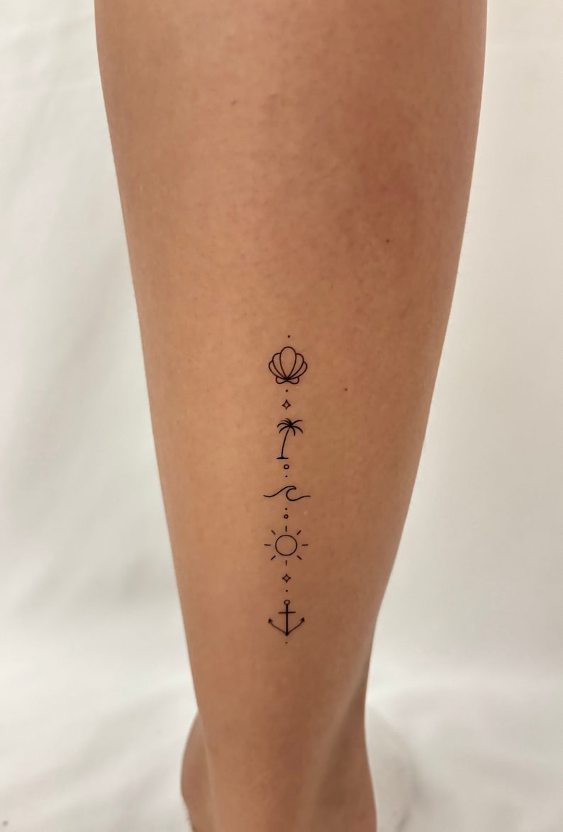 May include: A simple line art tattoo design on a person's leg. The design features a seashell, palm tree, wave, sun, and anchor.