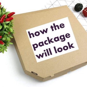 May include: A brown cardboard pizza box with a white label. The label has the text 'how the package will look' in bold, dark purple letters. The box is shown on a white surface with a small green plant with red peppers and some decorative balls in the background.