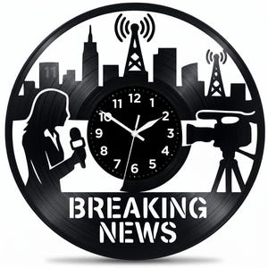 May include: Black vinyl record clock with a news theme. The clock features a cityscape silhouette, a news reporter, a video camera, and the words "BREAKING NEWS." The clock hands point to 1:10. The clock is a unique decorative item.