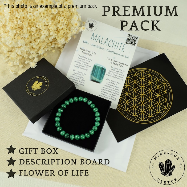 May include: A premium pack featuring a green malachite bracelet in a black gift box. The set includes a description board and a black card with a gold flower of life design. The text on the description board is in French.