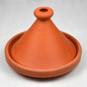 May include: A terracotta tagine with a conical lid and a wide base. The tagine is a traditional Moroccan cooking pot used for slow cooking.