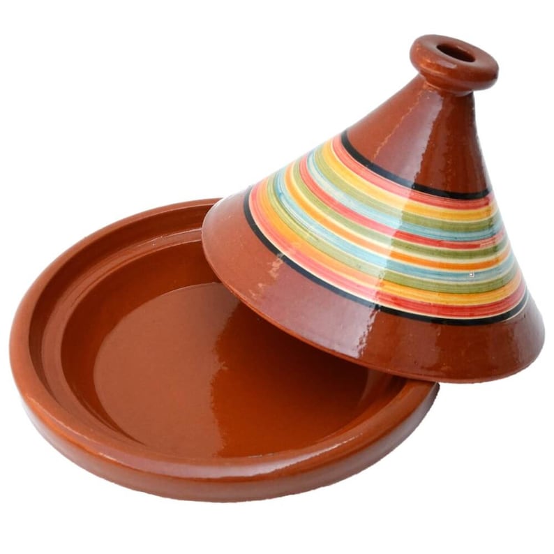 May include: A terracotta tagine with a colorful striped lid. The lid is cone-shaped and has a small knob on top. The tagine is a traditional Moroccan cooking pot.