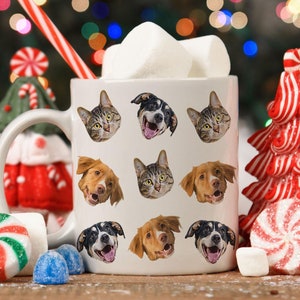 May include: White ceramic mug with a festive holiday design featuring multiple images of cats and dogs. The mug is filled with marshmallows and a red and white striped straw.