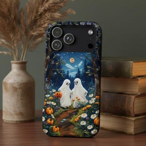 May include: A black phone case featuring a Halloween-themed illustration. The design depicts two white ghosts holding pumpkins, walking on a path through a forest under a starry night sky. Pumpkins and flowers line the path.