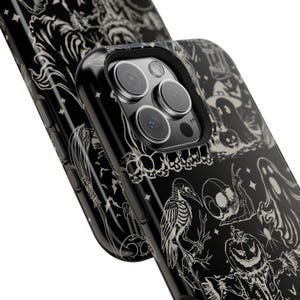 May include: Black phone case with a Halloween-themed design. The case features a repeating pattern of spooky illustrations in white, including ghosts, pumpkins, and skeletons. The phone case is shown at an angle, highlighting the detailed artwork.