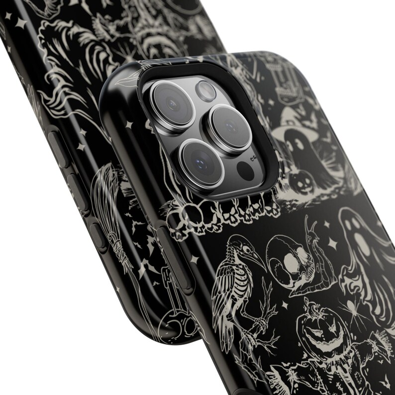 May include: Black phone case with a Halloween-themed design. The case features a repeating pattern of spooky illustrations in white, including ghosts, pumpkins, and skeletons. The phone case is shown at an angle, highlighting the detailed artwork.