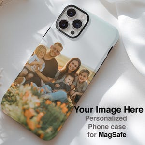 May include: A white phone case with a family photo, featuring a smiling family of five in a field of orange flowers. The case has a black border and text that reads "Your Image Here, Personalized Phone case for MagSafe."