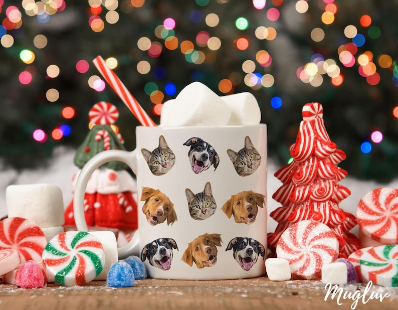 May include: White ceramic mug with a festive holiday design featuring multiple images of cats and dogs. The mug is filled with marshmallows and a red and white striped straw.