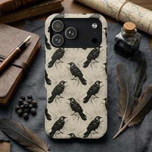 May include: A smartphone case featuring a repeating pattern of black crows on a cream-colored background. The design includes detailed illustrations of the birds in various poses, with subtle sketch-like lines and ink splatters surrounding each crow.