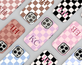 May include: Assortment of phone cases with checkered patterns in various colors. Each case features a different initial in a contrasting color. The initials include: KC, SH, LH, TH, EB, FT, SC, and HO.