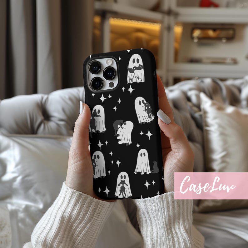 May include: Black phone case featuring a pattern of white ghosts and stars. The case has a glossy finish and a protective design. The design includes various ghost illustrations, some with cats. The text "Case Luv" is visible on the bottom right.