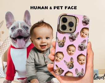 May include: A pink phone case featuring a repeating pattern of a baby's face and a dog's face. The phone case has a gold-colored camera ring. The words "HUMAN & PET FACE" are at the top of the image.