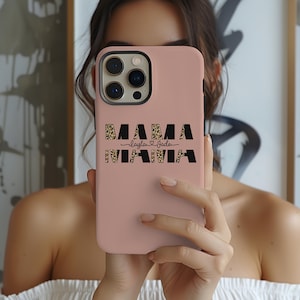 May include: A pink phone case with a black and brown leopard print design. The text "MAMA -layla & jade- MAMA" is printed on the case.