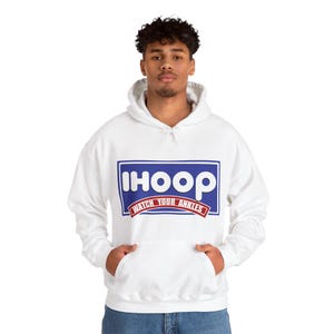 May include: White hooded sweatshirt with a blue and white logo that says "ihoop" and "watch your ankles" in red.