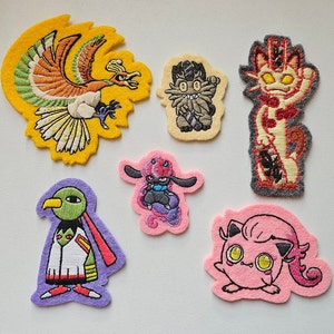 May include: Set of ten embroidered iron-on patches featuring various Pokemon characters. The patches are colorful and feature detailed embroidery.
