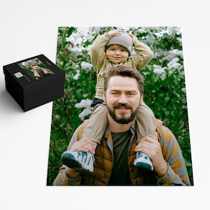 a photo of a man holding a child on his shoulders