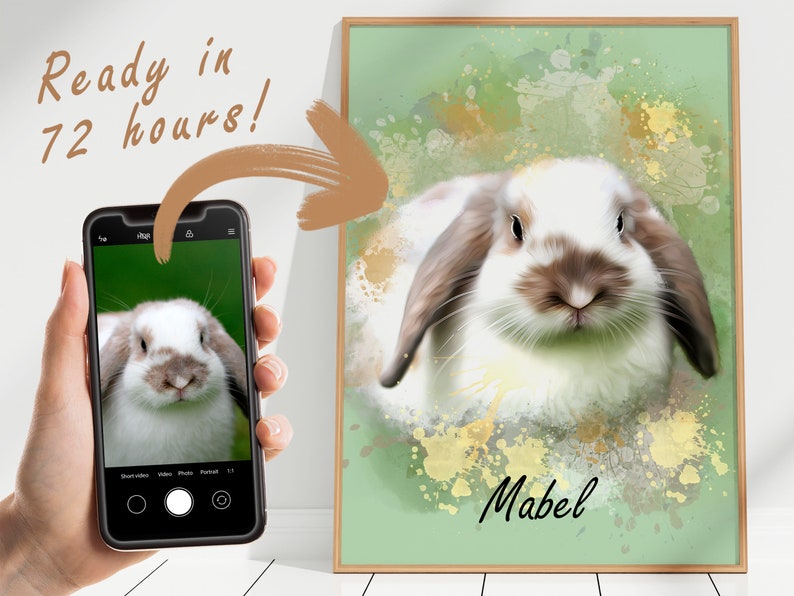 May include: A digital painting of a white and brown rabbit with floppy ears. The rabbit is looking directly at the viewer. The background is a green watercolor wash with gold splatters. The rabbit's name, "Mabel", is written in black below the rabbit.