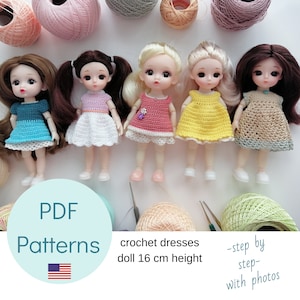 May include: Five dolls wearing handmade crochet dresses in blue, white, pink, yellow, and tan. The dolls are 16 cm tall. The image includes text that says "PDF Patterns" and "crochet dresses doll 16 cm height".