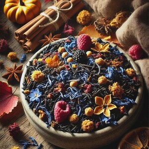 May include: A ceramic bowl filled with loose leaf tea, raspberries, and dried flowers sits on a wooden surface. Cinnamon sticks, star anise, and a small pumpkin are arranged around the bowl, creating a warm, inviting scene.